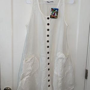 White beach cover up. Once size, would best fit small or medium